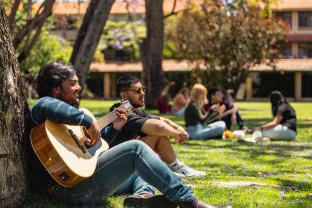 Trinity student playing the guitar